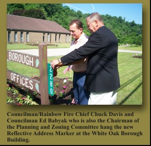 Councilman/Rainbow Fire Chief Chuck Davis and Councilman Ed Babyak who is also the Chairman of the Planning and Zoning Committee hang the new Reflective Address Marker at the White Oak Borough Building.